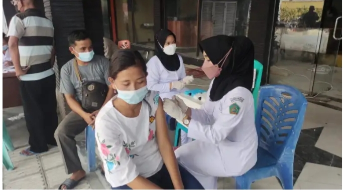 Personil Polresta Deli Serdang Memberikan Edukasi Dan Vaksinasi Massal